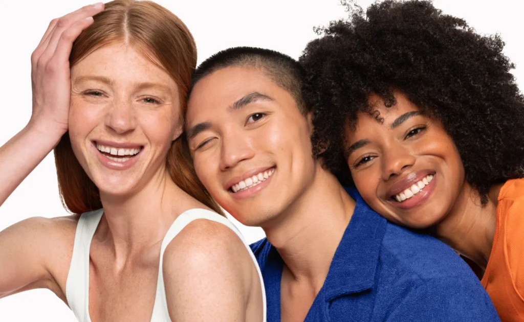 3 people smiling sitting next to each other close up