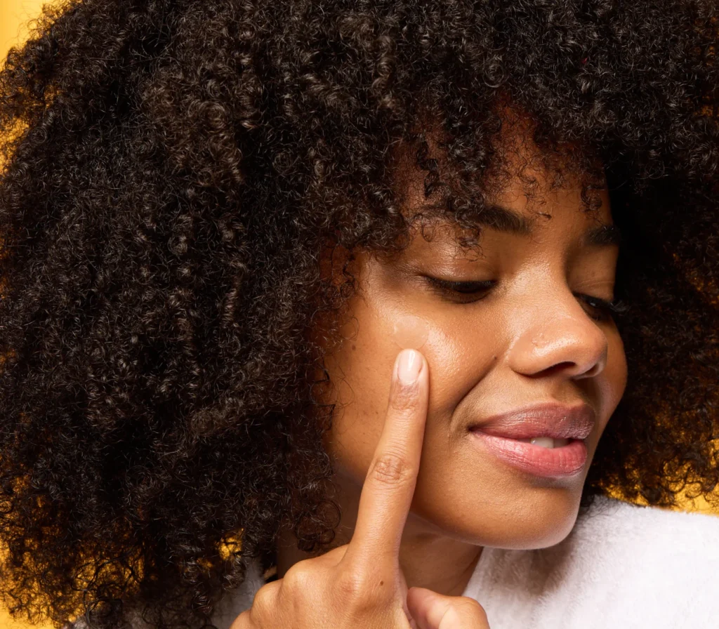 A woman with a PanOxyl overnight spot patch on her face.