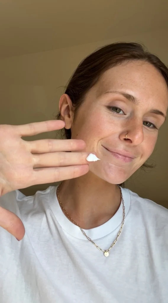 A woman showing PanOxyl product on her hand.