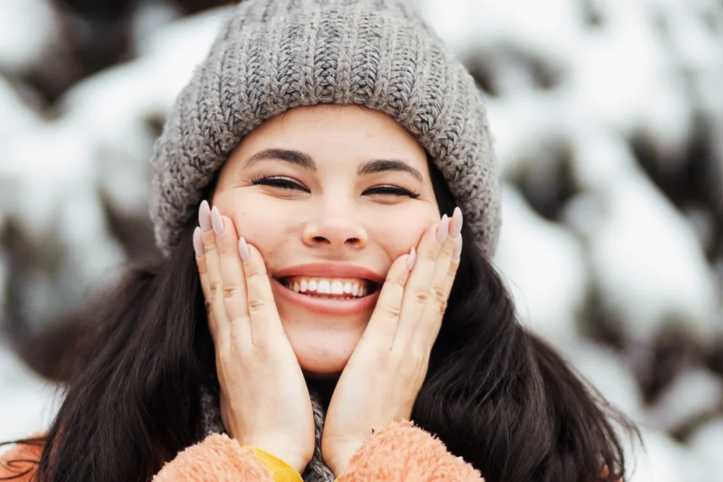 A woman in winter clothes smiling.