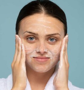 Woman applying PanOxyl to her face