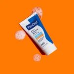 Thumbnail of A tube of PanOxyl Acne Foaming Wash with suds around it on an orange background