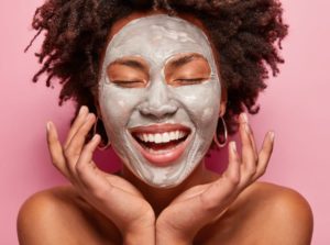 Woman with curly hair wearing a face mask