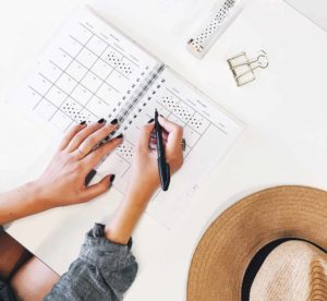 Woman writing in a planner