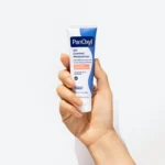 Thumbnail of Hand holding a tube of PanOxyl Oil Control Moisturizer