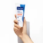 Thumbnail of Hand holding PanOxyl Balancing Repair Moisturizer on a white background