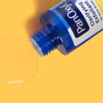 Thumbnail of An open bottle of PanOxyl Clarifying Exfoliant on an yellow background