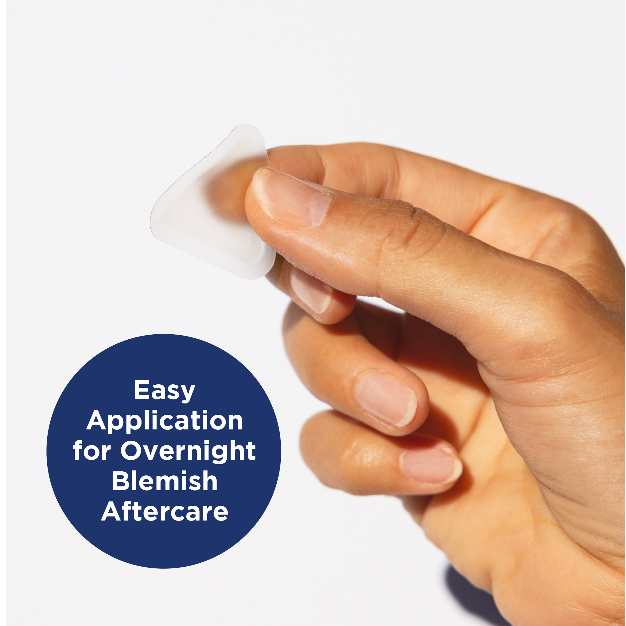 Hand holding one triangular patch. Easy application for overnight blemish aftercare.