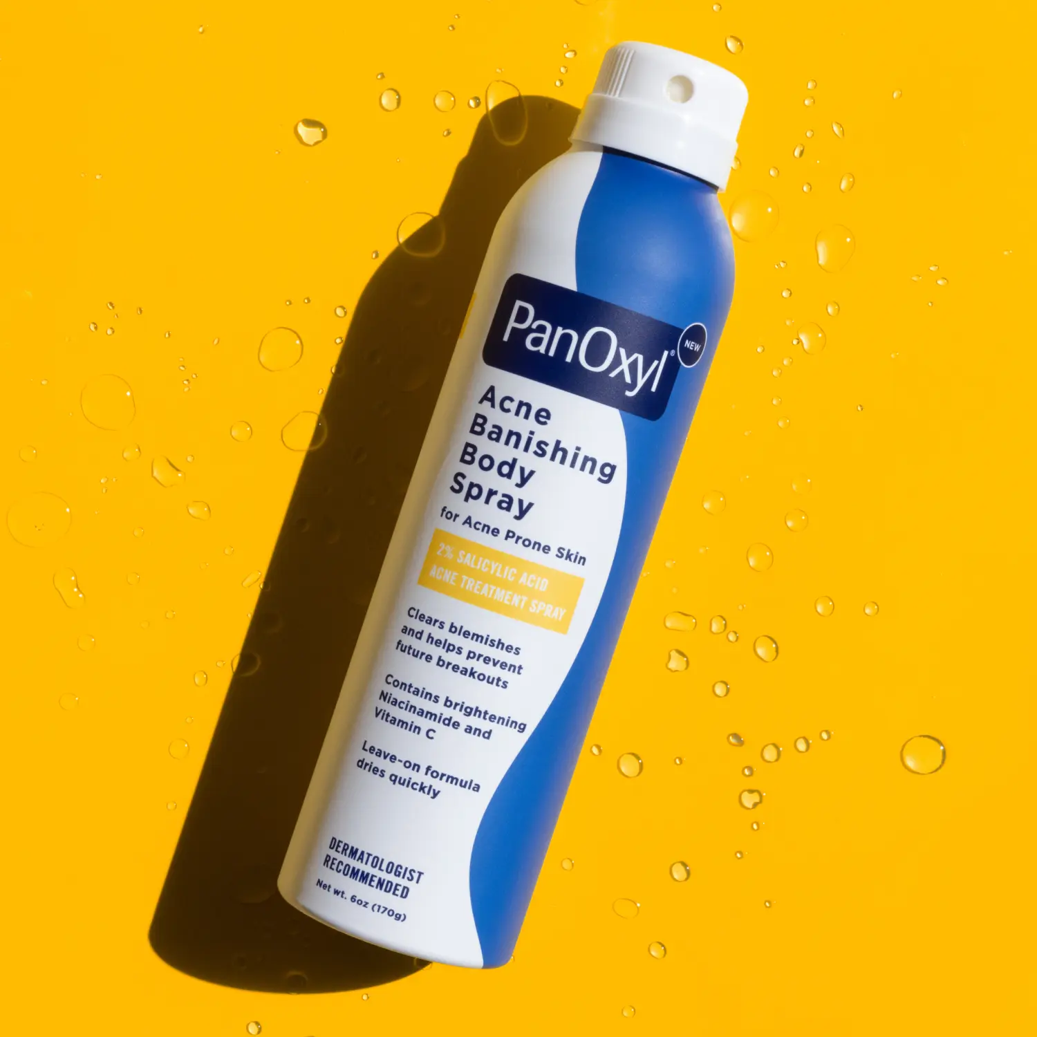 Aerosol bottle of PanOxyl Acne Banishing Body Spray on an yellow background