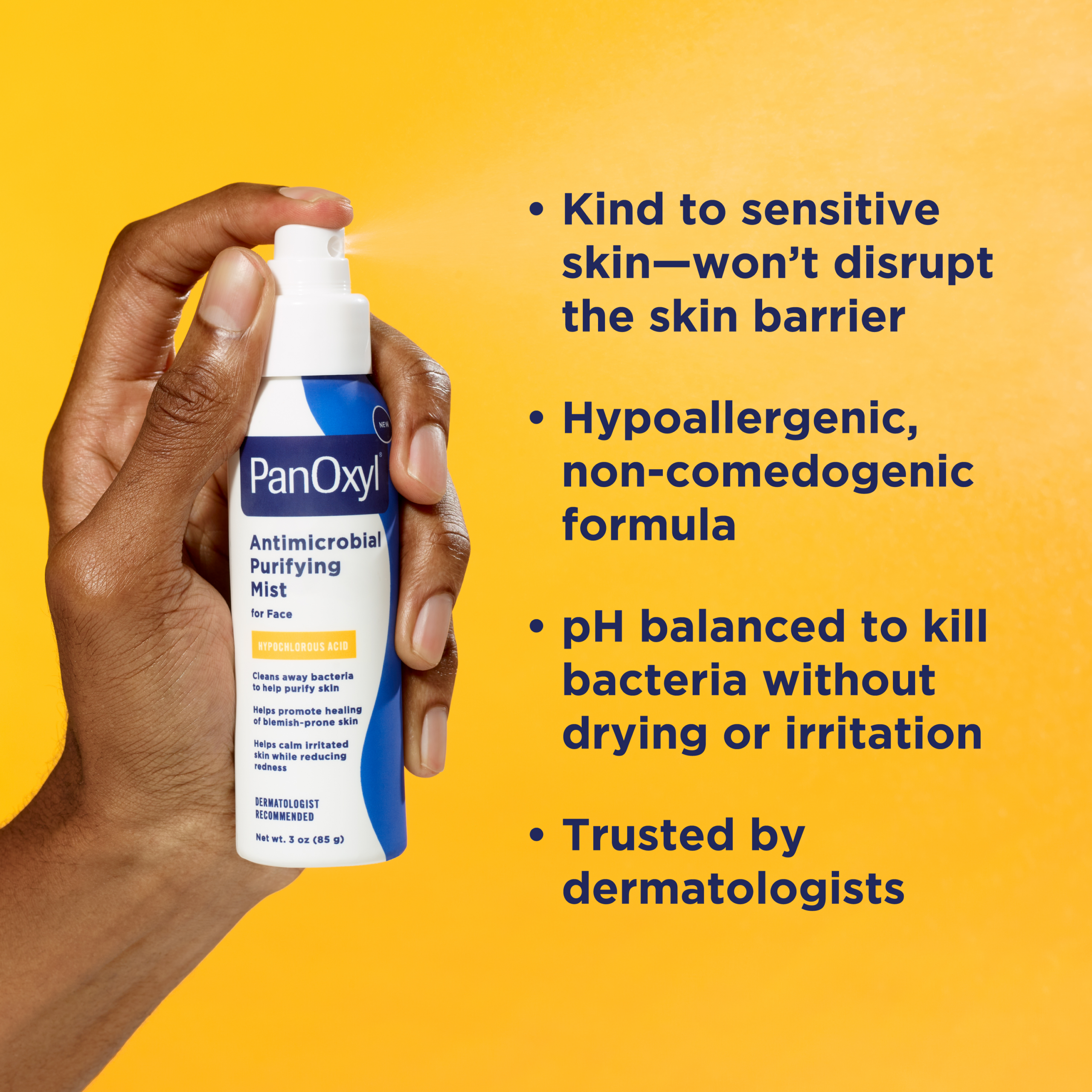 Hand holding PanOxyl Antimicrobial Purifying mist bottle and a list of it's benefits on a yellow background