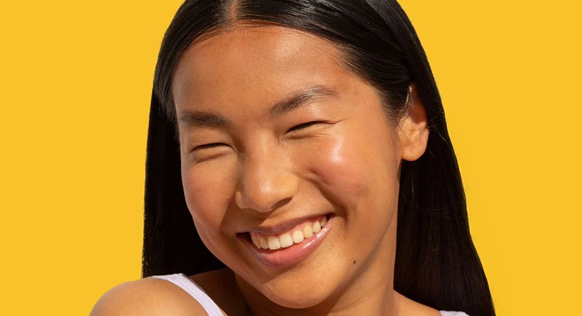 Smiling woman on a yellow background